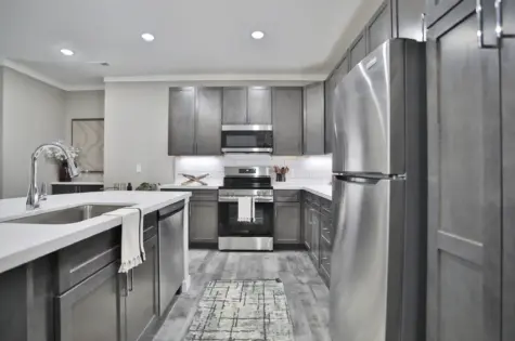 Altair Apartments in Florence, KY, view of stove and microwave. Quartz kitchen countertop, stainless steel frig