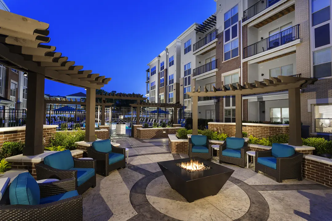 Social deck at 49Hundred Apartments featuring a cozy fire pit near the pool, surrounded by comfortable seating and ideal for outdoor gatherings and relaxation.