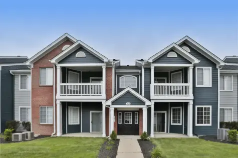 Exterior of a one-bedroom building at Emerald Lakes Apartments in Greenwood, Indiana, showcasing fresh exterior paint, updated finishes, and attractive landscaping in a quiet residential setting.
