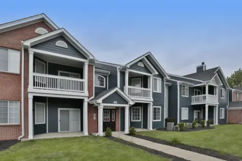 Exterior of a one-bedroom building at Emerald Lakes Apartments in Greenwood, Indiana, showcasing fresh exterior paint, updated finishes, and attractive landscaping in a quiet residential setting.
