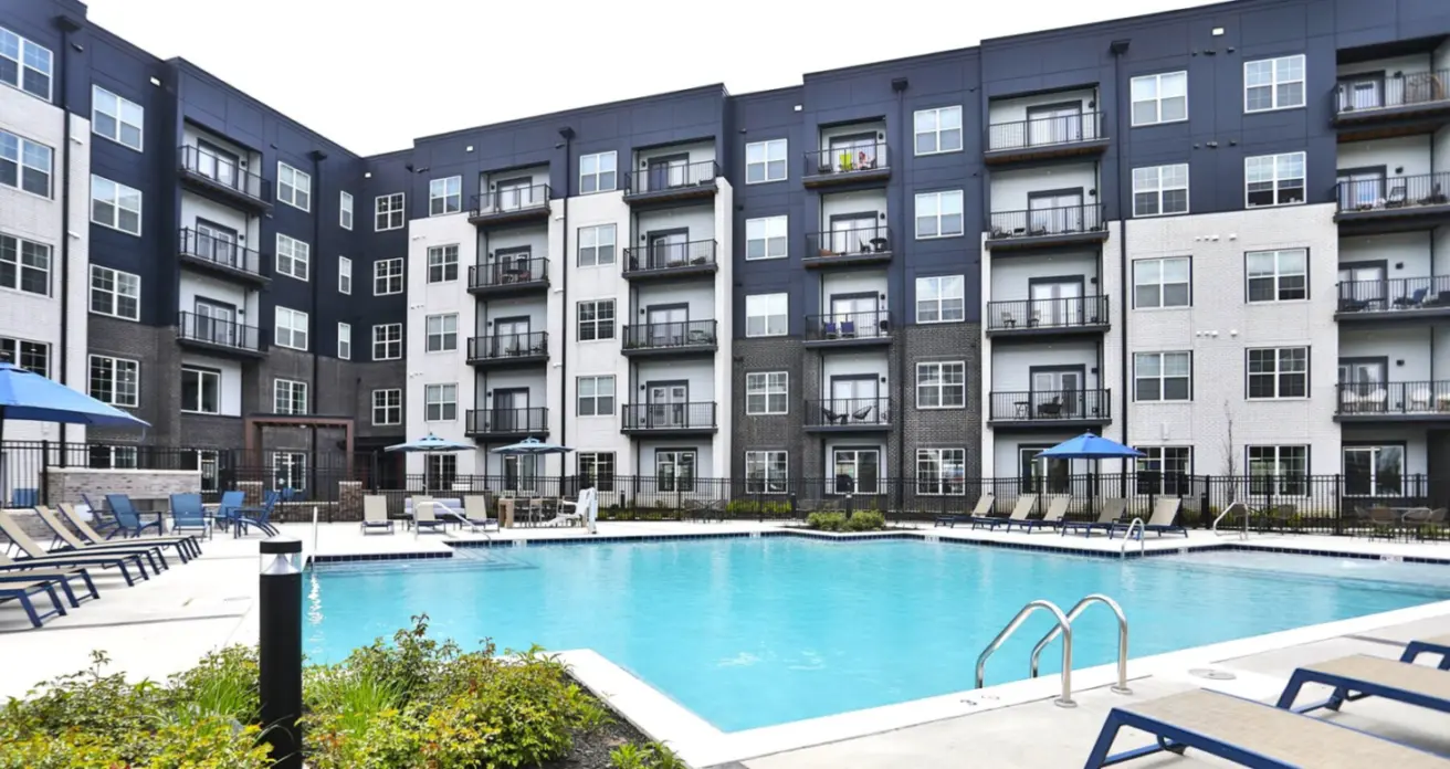 Swimming pool and social deck at Graphite Oakley featuring a modern pool surrounded by lounge seating, stylish decking, and shaded areas designed for relaxation and community gatherings.