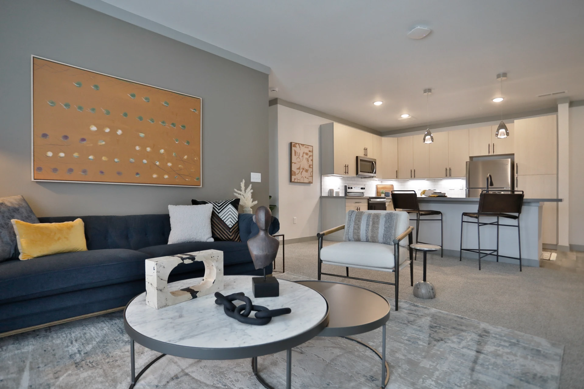 Graphite Oakley Grand Opening. View of Model 1 floor plan apartments. Kitchenette, living room