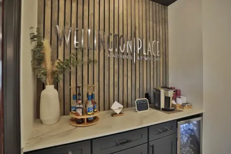 Coffee bar at Wellington Place Apartments featuring a variety of coffee options, flavored syrups, and a modern setup for residents to enjoy a fresh brew any time of day.