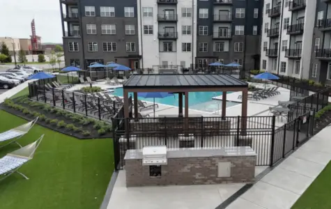 Graphite Oakley swimming pool with sundeck and grilling station.