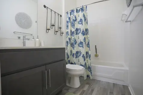 Reserve at Miller Farm guest bathroom with tub and shower combo and quartz vanity.