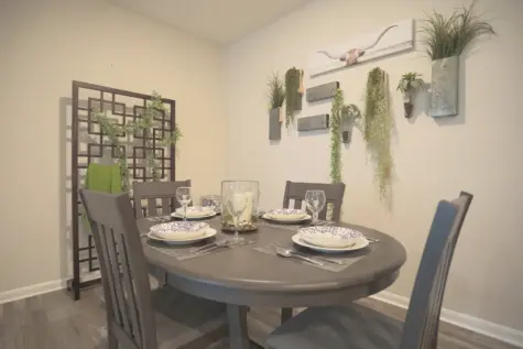 Reserve at Miller Farm dining room with handsome woodgrain flooring and dining room table and chairs.