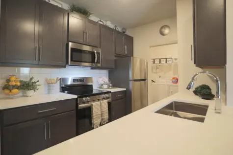 Reserve at Miller Farm kitchen featuring quartz counters and stainless steel appliances.