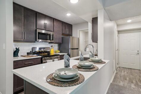 Renovated apartment kitchen with modern cabinetry and island seating in Southgate, KY.