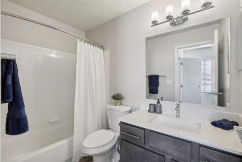 Modern bathroom with updated fixtures and tile finishes at Fox Chase South Apartments.