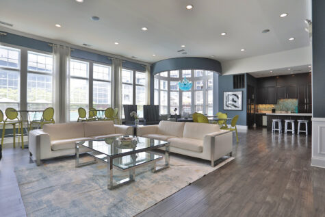 Rentable multipurpose room at Kendal on Taylorsville designed for gatherings and events, featuring comfortable seating, a shuffleboard table, and a full kitchen for entertaining.