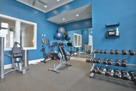 State-of-the-art fitness center at Kendal on Taylorsville featuring cardio machines, strength training equipment, and a dedicated yoga and stretching area for a well-rounded workout experience.