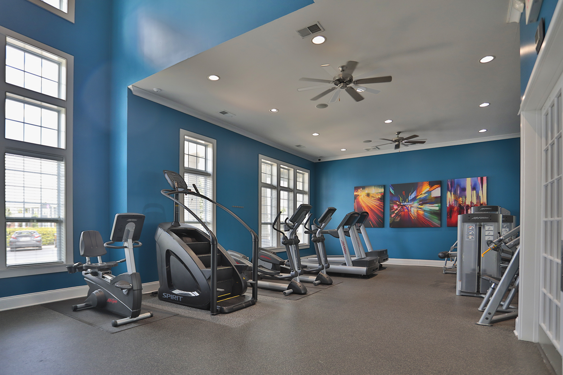 State-of-the-art fitness center at Kendal on Taylorsville featuring cardio machines, strength training equipment, and a dedicated yoga and stretching area for a well-rounded workout experience.