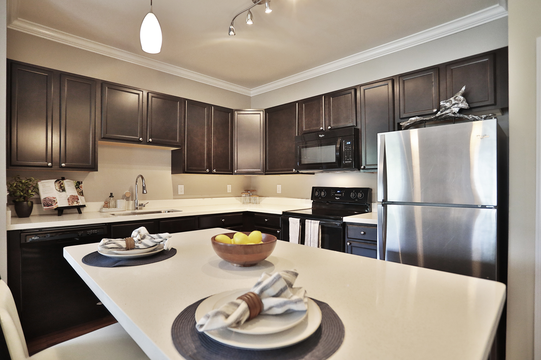 Modern kitchen at Kendal on Taylorsville with quartz countertops, stainless steel appliances, and white shaker cabinets.