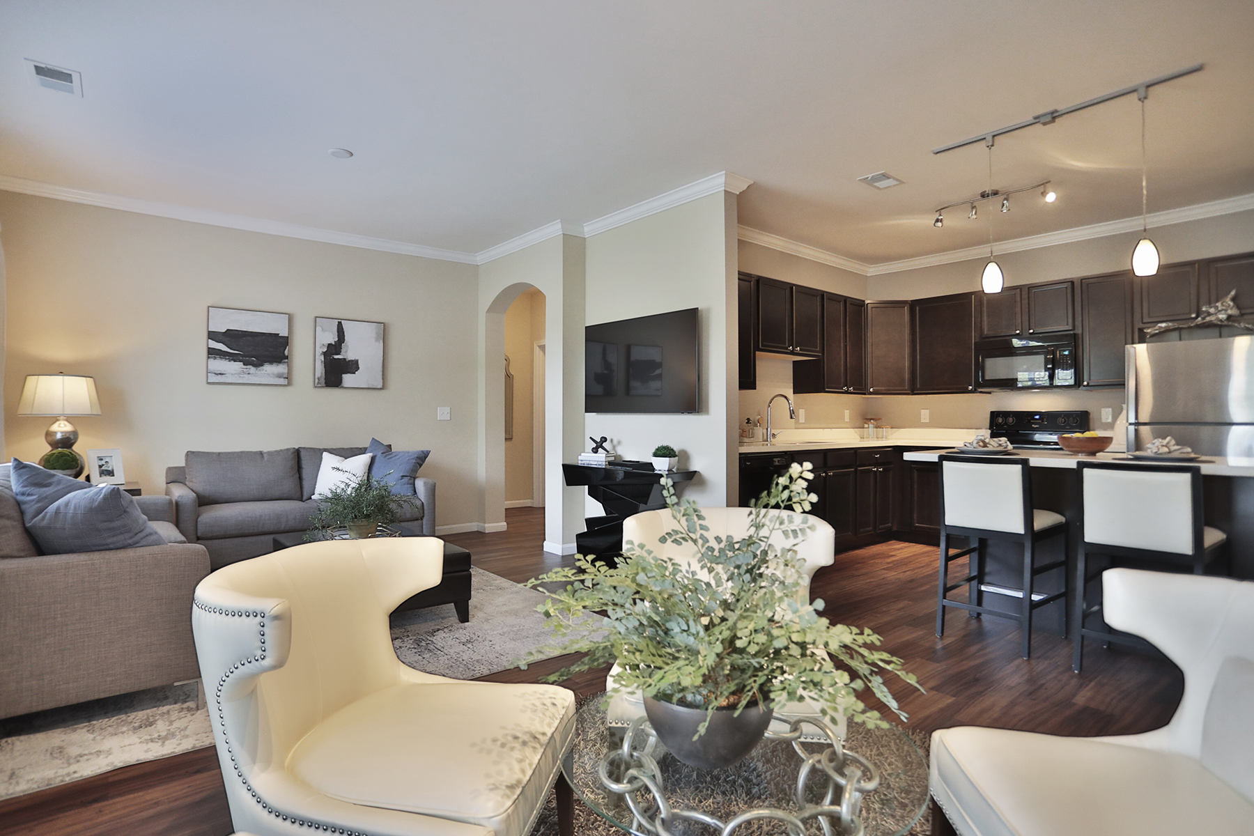 Model apartment interior at Kendal on Taylorsville highlighting the open living area, dining space, and kitchen designed for modern apartment living.