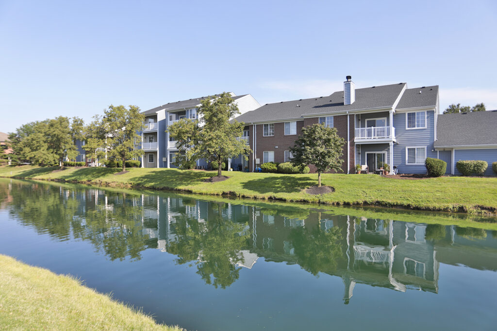 Aerial-style view of The Landings at Beckett Ridge featuring community ponds, green space, and multi-story buildings with balconies and garages.