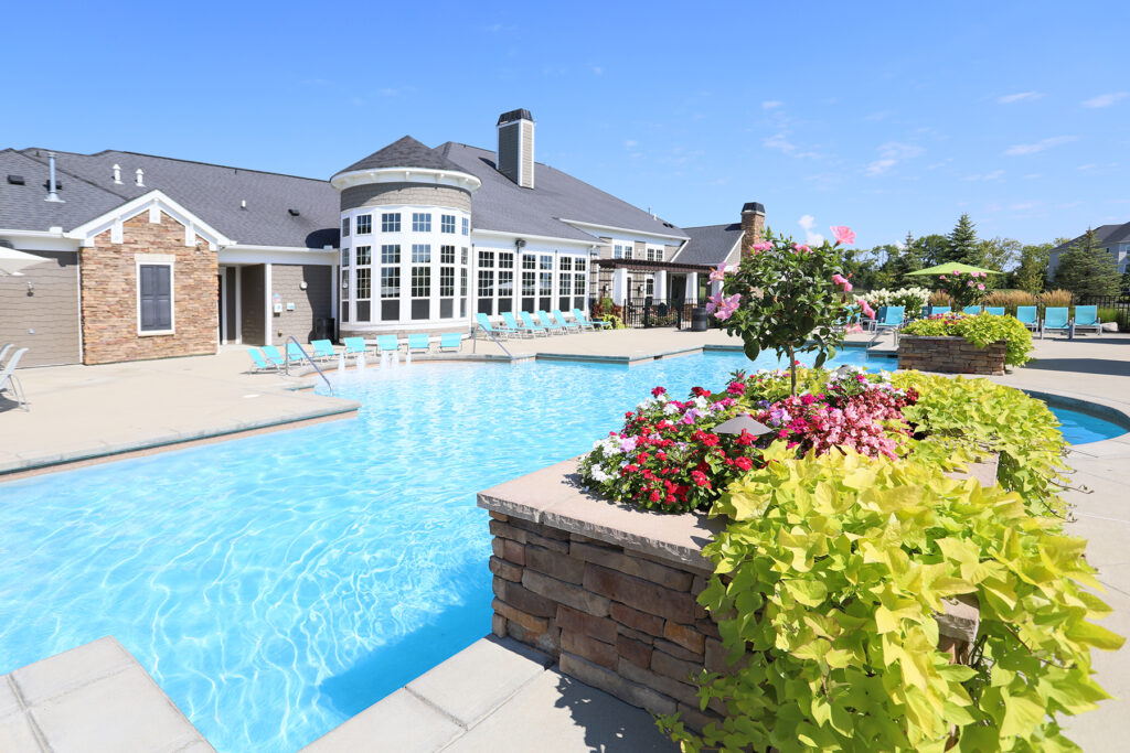 Palmera Apartments resort-style swimming pool surrounded by flowers