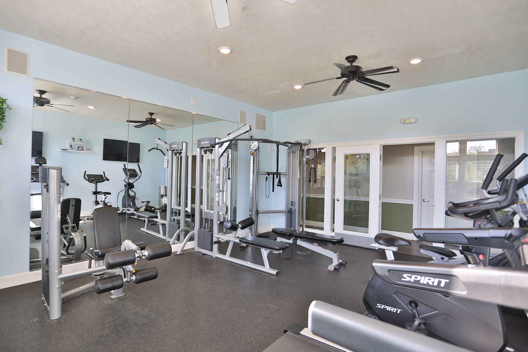 Waterford Place fitness center with cardio equipment and free weights