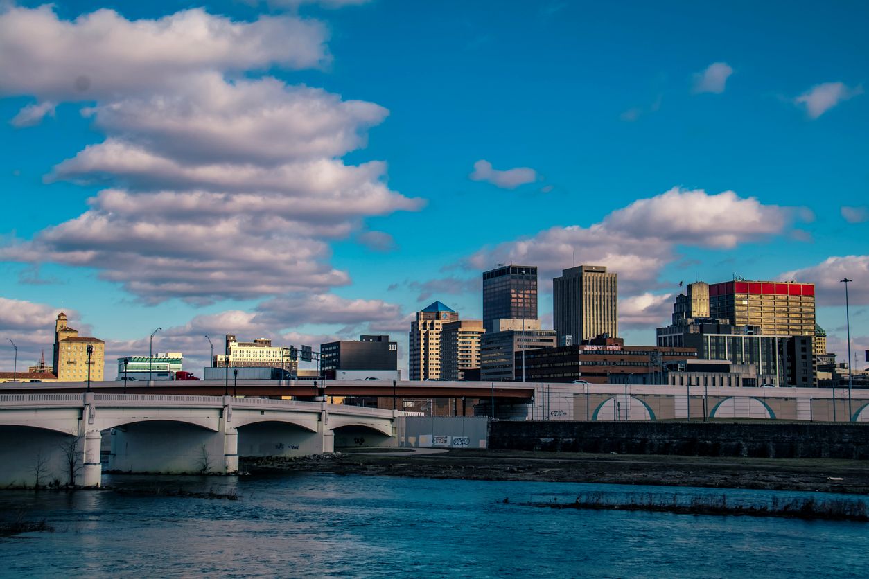 The skyline of Dayton, OH, with beautiful clouds dotting the blue skies above.