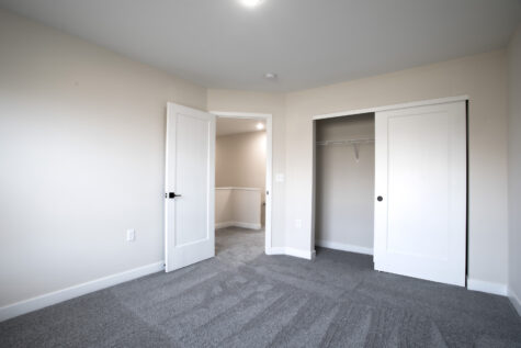 Secondary bedroom in 3 bedroom townhome at Relay 129 featuring neutral finishes, large windows, and walk-in closet.
