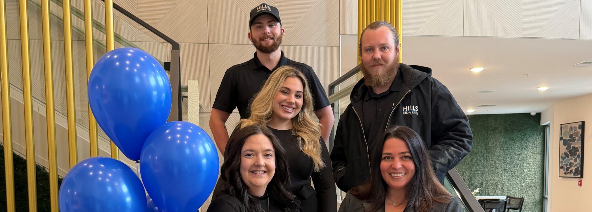 Five HILLS employees smile after receiving recognition for their work at Vantage at Anderson Towne Center.