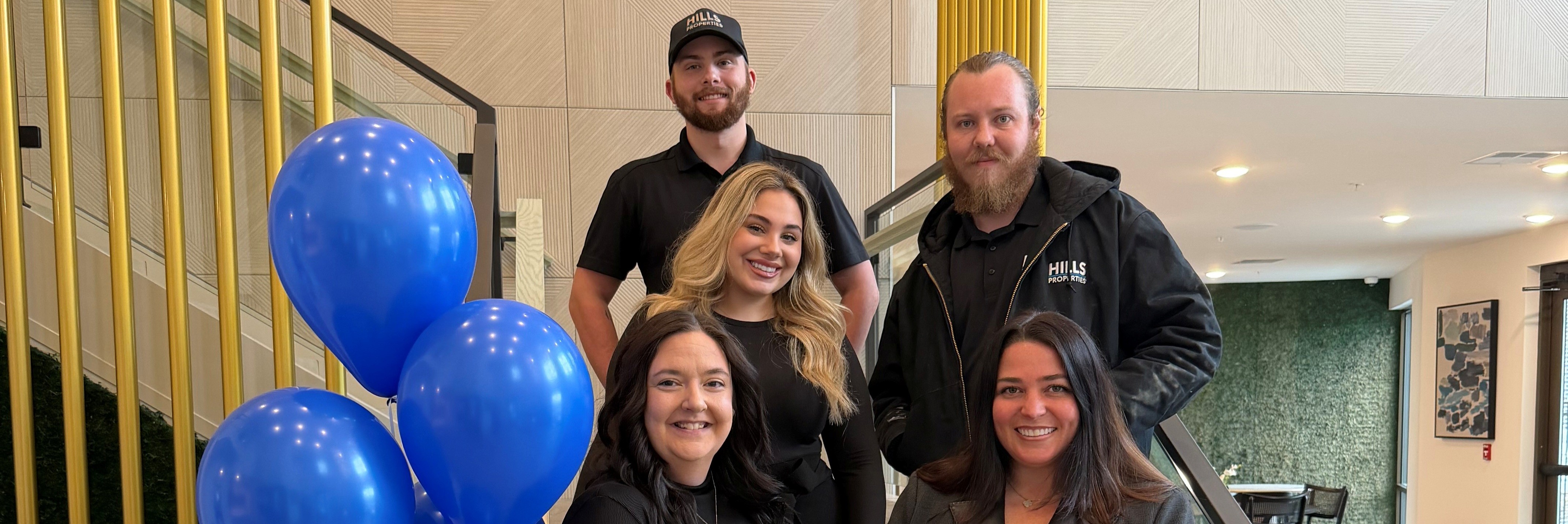 Five HILLS employees smile after receiving recognition for their work at Vantage at Anderson Towne Center.