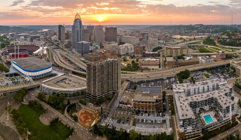 Cincinnati, Ohio, sunset on an urban landscape. Downtown district skyline with brightly illuminated high skyscraper buildings in a modern American city.
